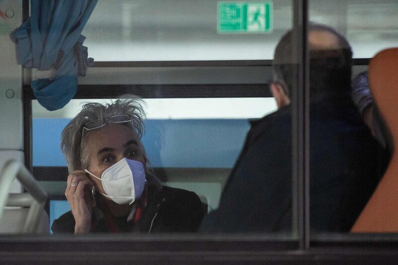 Marion Koopmans, from the Netherlands' Erasmus Medical Centre Department of Viroscience and member of  the WHO team investigating the origins of the Covid-19 pandemic, on a bus following her arrival at a cordoned-off section in the international arrivals area at the airport in Wuhan. AFP