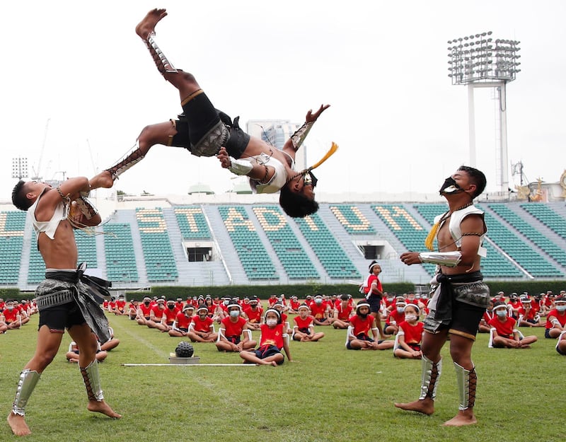 Young Muay Thai fighters perform a traditional ritual during a Wai Kru Muay Thai dance ceremony at the National Stadium in Bangkok, Thailand, on Friday, August 7. EPA