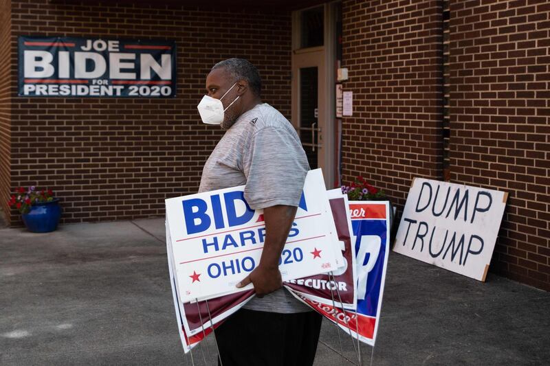 Tony Hickson holds signs in support of Joe Biden in Youngstown, Ohio, on September 22, 2020.  Ohio has been a political prize for generations of candidates wooing the state's diverse voting demographic, which closely mirrors the nation and has offered a reliable gauge of American sentiment. AFP
