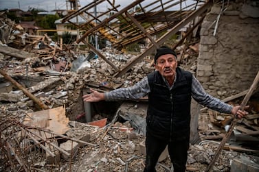 Retired police officer Genadiy Avanesyan, 73, searches for belongings in the remains of his house, which is said was destroyed by Azeri shelling, in the city of Stepanakert on October 10, 2020. Amenia and Azerbaijan traded accusations of new attacks on October 10 in breach of a ceasefire deal to halt nearly two weeks of fierce fighting over the disputed Nagorno-Karabakh region. Aris Messinis / AFP / ARIS MESSINIS