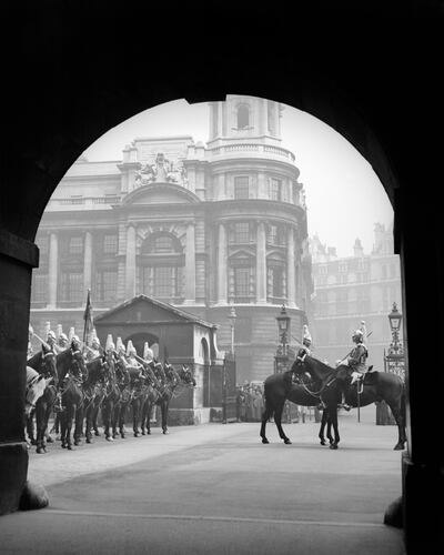 Mounted horse guards are seen outside the Old War Office in the 1930s. Getty 