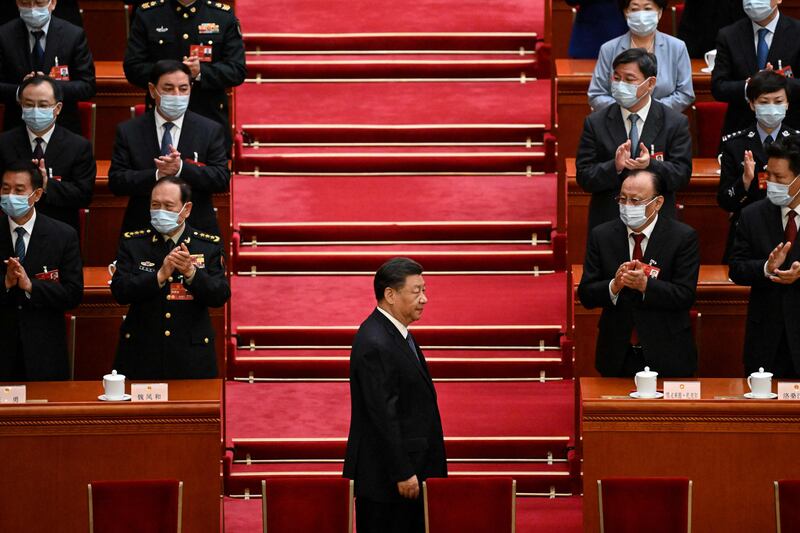 Chinese President Xi Jinping is applauded as he arrives for the fifth plenary session of the National People's Congress at the Great Hall of the People in Beijing on Sunday. AFP