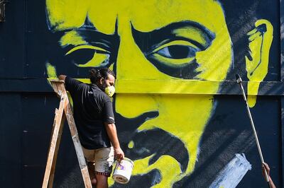 Artists work on a mural of late Bollywood actor Irrfan Khan on a wall in a neighbourhood in Mumbai on May 1, 2020. Acclaimed Indian actor Irrfan Khan, whose international movie career included hits such as "Slumdog Millionaire", "Life of Pi" and "The Amazing Spider-Man", died at the age of 53 on April 29. / AFP / Indranil MUKHERJEE
