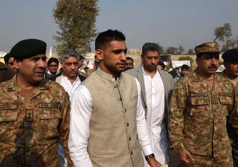 Boxer Amir Khan arrives on Monday at the army-run school where the Taliban massacred 148 people on December 16. A Majeed / AFP