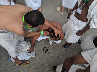 A man has his head shaved during the Hajj pilgrimage in Makkah, Medina.