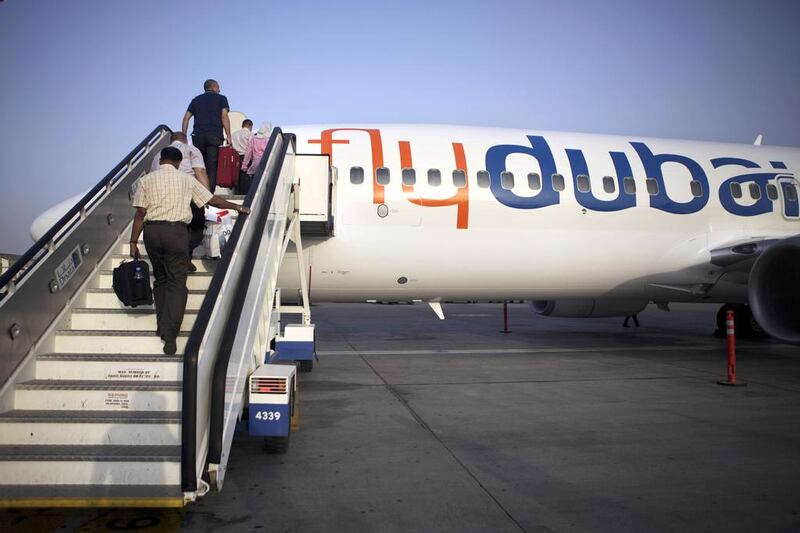 Passengers board a flydubai flight. Low-cost airlines offer an alternative for UAE travellers.  Galen Clarke / The National