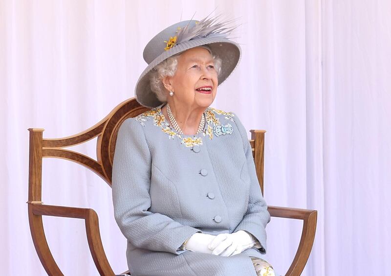 Queen Elizabeth II beams as she watches the Red Arrow fly past. AFP
