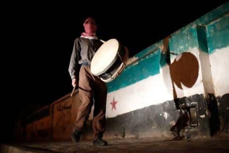 A drummer rouses residents to have their pre-dawn suhoor meal before fasting as part of Ramadan in a rebel held town, north east of Damascus.