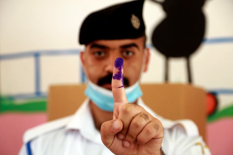 An Iraqi federal policeman ​after voting early in Iraq's parliamentary election. AP Photo