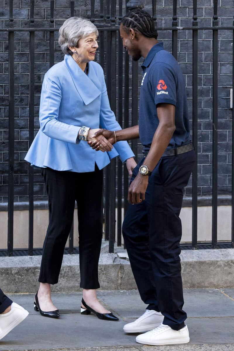 British prime minister Theresa May shakes hands with England fast bowler Jofra Archer. AFP