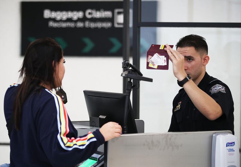 MIAMI, FL - FEBRUARY 27:  A U.S. Customs and Border Protection officer uses facial recognition technology in his booth at Miami International Airport to screen a traveler entering the United States on February 27, 2018 in Miami, Florida.  The facility is the first in the country that is dedicated to providing expedited passport screening via facial recognition technology, which verifies a traveler's identity by matching them to the document they are presenting.  (Photo by Joe Raedle/Getty Images)