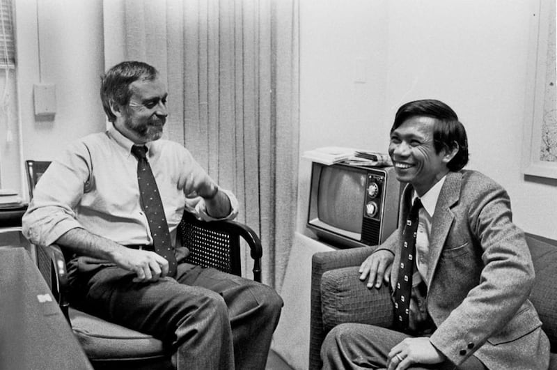 In this Jan. 15, 1980 photo,  Sydney Schanberg, left, talks with his Cambodian assistant Dith Pran at the New York Times office in New York. Schanberg, the Pulitzer Prize-winning correspondent for The New York Times, whose coverage in Cambodia in 1975 inspired the film "The Killing Fields," has on July 9, 2016 at the age of 82. The New York Times via AP