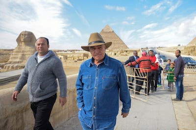 Prominent Egyptian archaeologist and former minister of antiquities, Zahi Hawas, is pictured in from of the Sphynx during a visit to the historic site of the Giza Pyramids, south of Cairo, on December 6, 2017. (Photo by MOHAMED EL-SHAHED / AFP)