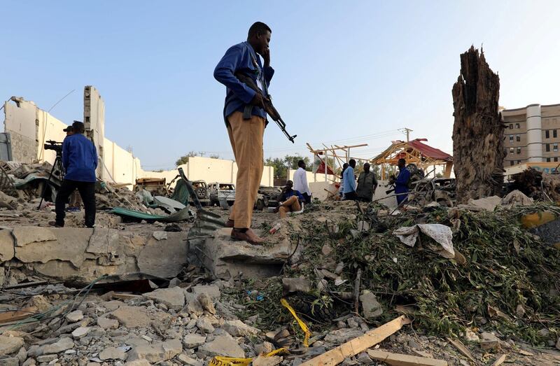 Security officers stand at the scene after a suicide car explosion in front of Doorbin hotel in Mogadishu, Somalia. Feisal Omar / Reuters