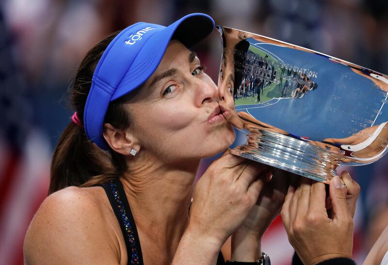 FILE - In this Sunday, Sept. 10, 2017 file photo, Martina Hingis, of Switzerland, kisses the women's doubles championship trophy next to partner Chan Yung-Jan, of Taiwan, not pictured, after beating Katerina Siniakova, of Czech Republic, and Lucie Hradecka, of the Czech Republic, in the women's doubles final of the U.S. Open tennis tournament. Martina Hingis announced Thursday, Oct. 26 that she will retire from tennis for the third time in her career at the end of the ongoing WTA Finals. The Swiss initially confirmed the news on Twitter and Facebook after winning her quarterfinal doubles match.(AP Photo/Julie Jacobson, File)