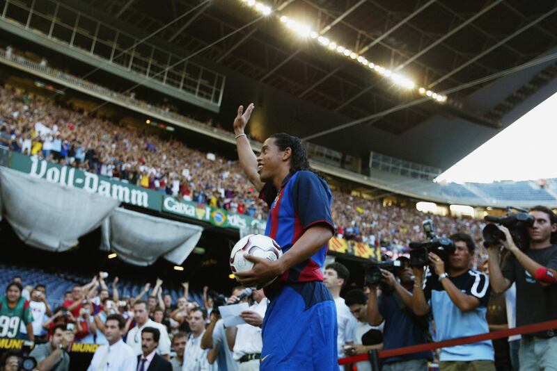 Ronaldinho waves to the fans inside Camp Nou during his unveiling as a Barcelona player on July 21, 2003. Getty Images