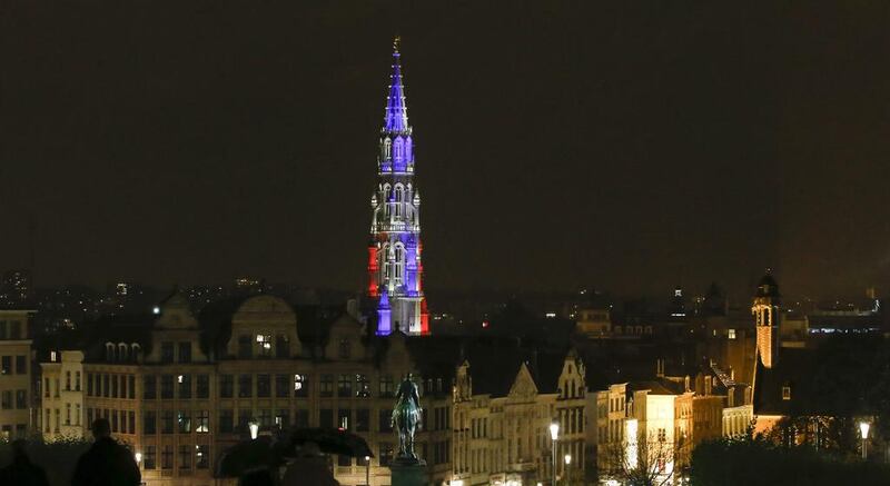 Brussels City hall tower is illuminated in the colours of the French flag, in Brussels, Belgium. Oliver Hoslet/EPA