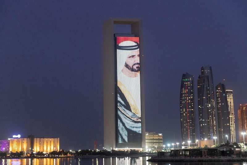ABU DHABI, UNITED ARAB EMIRATES. 19 JULY 2018. A LED screen plays portraits of the UAE Leadership along with a message in Mandari honouring the Chinese Prime Ministers state visit to the UAE on the ADNOC HQ building on the Corniche. (Photo: Antonie Robertson/The National) Journalist: None. Section: National.