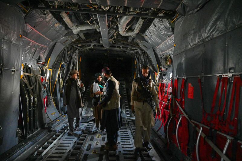 Taliban fighters inside an Afghan Air Force aircraft. AFP