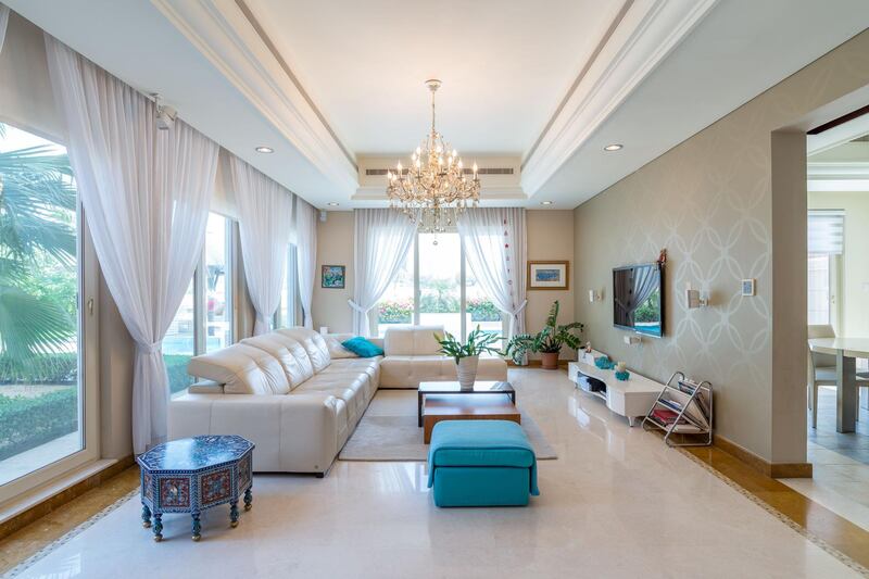 The living room has a simple layout and style. Courtesy LuxuryProperty.com