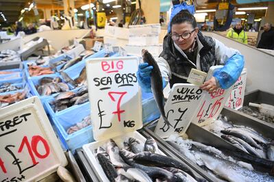 A trader adjusts her display of seabass at Billingsgate Fish Market in London. EPA