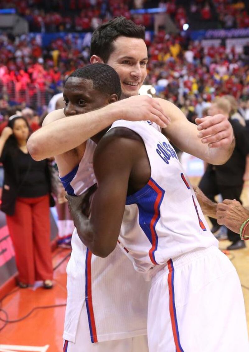JJ Redick, left, and Darren Collison hug after the Los Angeles Clippers beat the Golden State Warriors in Game 7. Stephen Dunn / Getty Images

