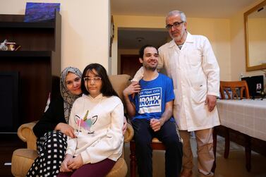 Manal Tamim with her daughter Sama, son Al Moutaz Bella and husband Jamal Abu Laban. The family fled from Syria in 2012 and now live in Ajman. Pawan Singh / The National