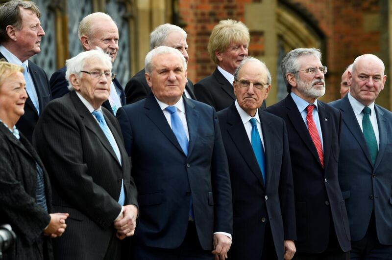 Bertie Ahern, former U.S. Senator George Mitchell, Seamus Mallon, David Trimble and Gerry Adams stand with others for a group photograph at an event to celebrate the 20th anniversary of the Good Friday Agreement, in Belfast, Northern Ireland, April 10, 2018. REUTERS/Clodagh Kilcoyne