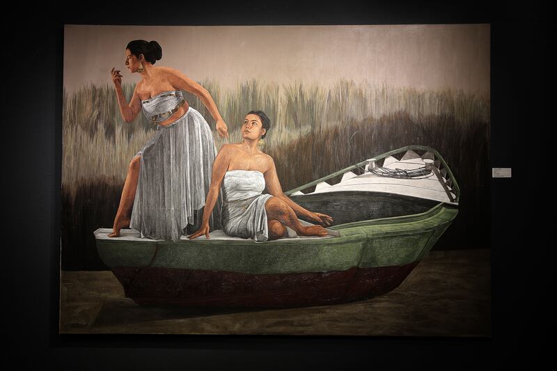 Salvation has two women posing on a boat, blades of tall grass rising in the background and water flowing underneath