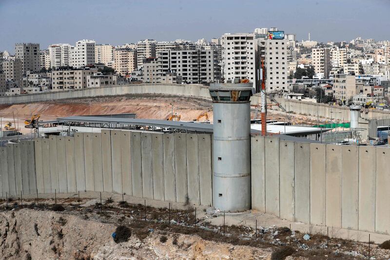 Israel's controversial wall and machinery working on the tarmac of the former Jerusalem airport, which has been closed to civilian traffic since the outbreak of the second Palestinian intifada in 2000. AFP