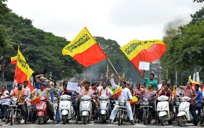 File: Pro-Karnataka activists wave the Karnataka flag during a motorcycle rally on September 9, 2016, as part of a statewide strike in Bangalore, India. Agitation in the southern Indian state of Karnataka has been increasing since a recent Supreme Court order to release water from the River Cauvery each day to the neighbouring state of Tamil Nadu.  Agence France-Presse