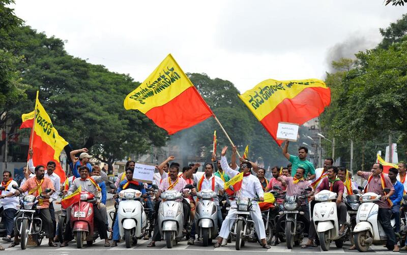 Pro-Karnataka activists wave the Karnataka flag during a motorcycle rally on September 9, 2016, as part of a statewide strike in Bangalore, India. Agitation in the southern Indian state of Karnataka has been increasing since a recent Supreme Court order to release water from the River Cauvery each day to the neighbouring state of Tamil Nadu. Karnataka is facing an acute shortage of water in its reservoirs and rivers as the state has only received subpar rainfall in the catchment areas leading to protests by farmers and pro-Kannada organisations refusing to share water with its neighbouring state. Manjunath Kiran / Agence France-Presse