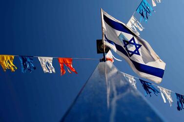 An Isreali flag flies. The National