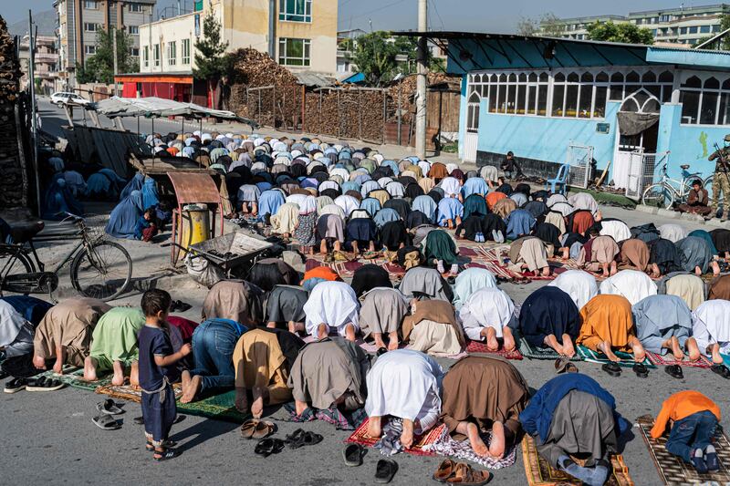 Muslim devotees pray outside a mosque in the middle of a street in Kabul. AFP