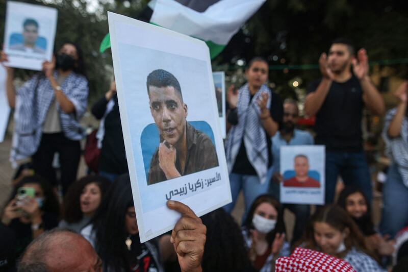 Protesters in Nazareth carry Palestinian flags and placards depicting the six inmates who  escaped from Israel's Gilboa prison. AFP