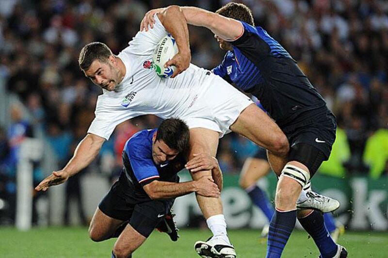 Ben Foden, the England fullback, is stopped in his tracks by the resolute French defence of scrum-half, Dimitri Yachvili, left, and the lock, Pascal Pape.

Franck Fife / AFP
