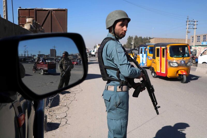 Afghan security officials stand guard on a road side check point in Herat, Afghanistan. EPA