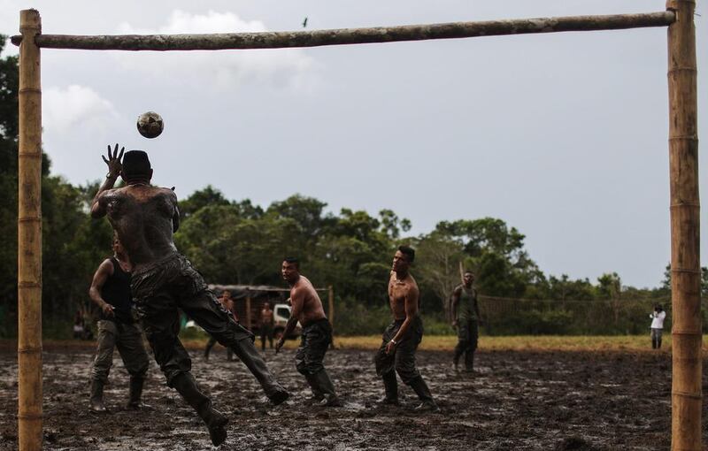 FARC (Revolutionary Armed Forces of Colombia) rebels play football in the mud at their camp following the 10th Guerrilla Conference in the remote Yari plains where the peace accord was ratified by the FARC in El Diamante. The peace agreement attempts to end the 52-year-old guerrilla war between the FARC and the state, the longest-running armed conflict in the Americas which left 220,000 dead. The final agreement is set to be signed on September 26 and will then be put to vote by the public in a referendum on October 2. The plan calls for a disarmament and re-integration of most of the estimated 7,000 FARC fighters. Mario Tama / Getty Images