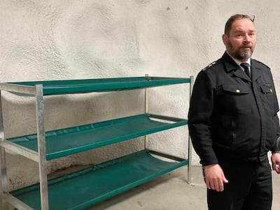 Tomi Rask, a preparedness teacher from Finland's civil defence unit, next to bunks in the Merihaka shelter, Helsinki. Thomas Harding / The National
