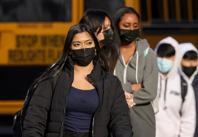Pupils leave a high school in Arlington County, one of several school districts which sued to stop the mask-optional order by Governor Glenn Youngkin, in Arlington, Virginia. Reuters