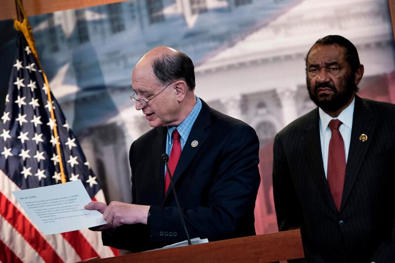 (FILES) This file photo taken on June 7, 2017 shows US Representative Brad Sherman (L), Democrat of California,  and US Representative Al Green, Democrat of Texas, taking questions about articles of impeachment against US President Donald Trump during a press conference on Capitol Hill in Washington, DC.
Sherman on July 12, 2017, became the first US lawmaker to formally file an article of impeachment against President Donald Trump, but the effort is likely to stall in the Republican-controlled Congress. / AFP PHOTO / Brendan Smialowski