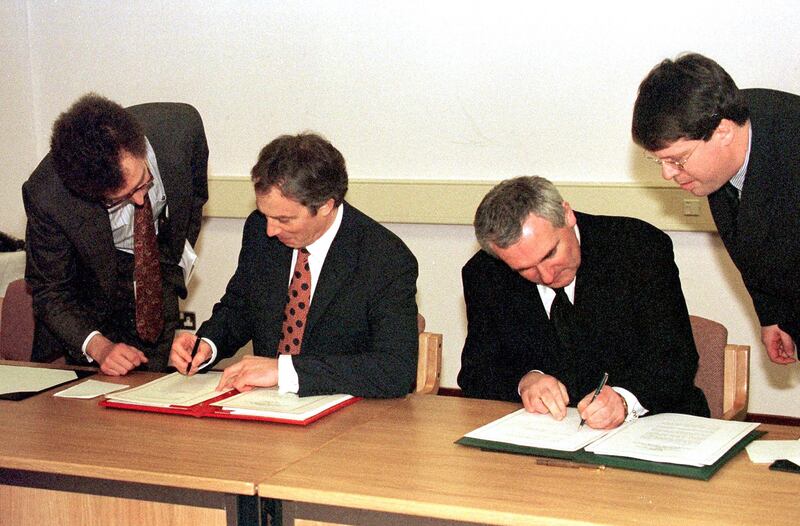 Former British prime minister Tony Blair and former Taoiseach Bertie Ahern sign the Good Friday agreement on April 10, 1998. This year marks 25 years since the signing of the historic agreement. PA