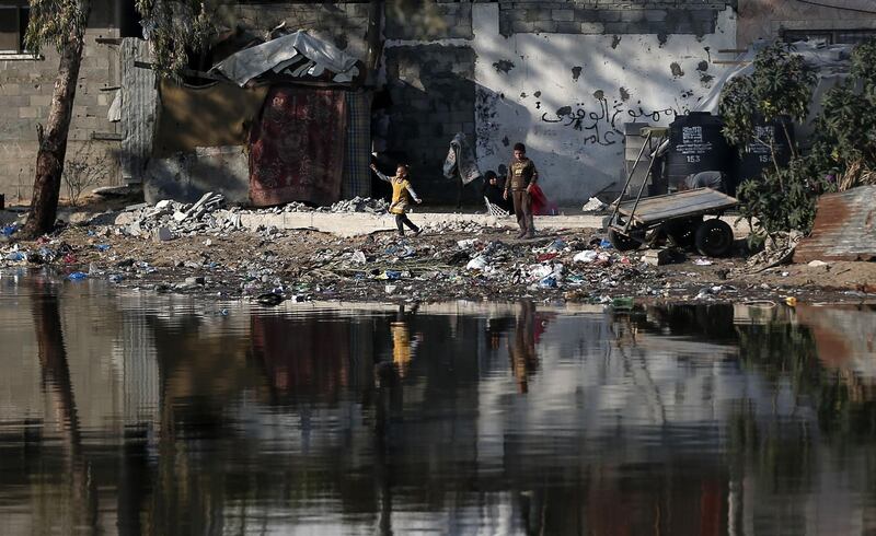 Palestinian childen play in an impoverished neighbourhood in Gaza city.   AFP