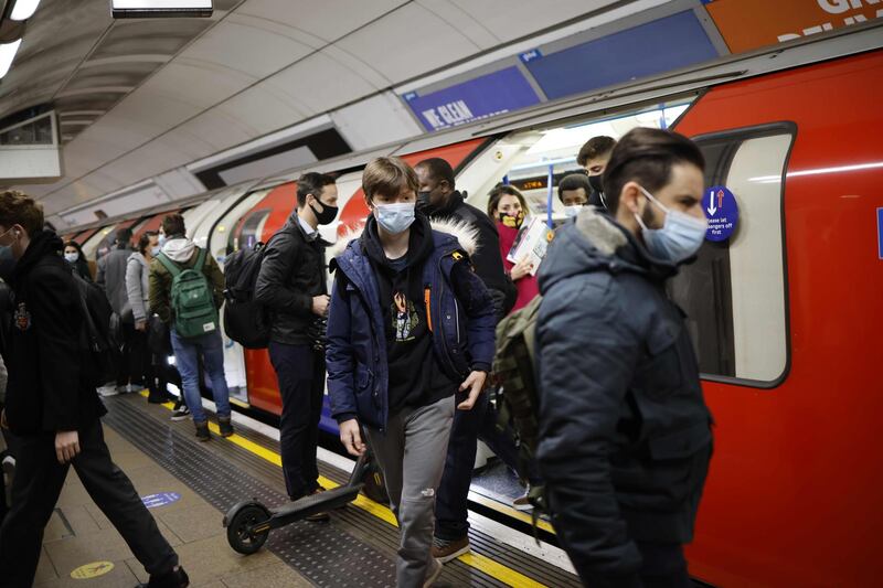 Passengers exit a London Underground tube train during the morning rush hour. AFP