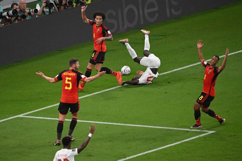 Canada's defender #22 Richie Laryea falls after a challange by Belgium's midfielder #06 Axel Witsel during the Qatar 2022 World Cup Group F football match between Belgium and Canada. AFP