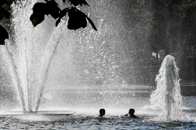 Children cool down in the fountain at Spikersuppa in Oslo. AFP