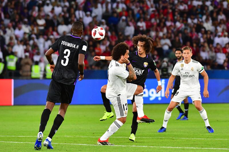 Al Ain midfielder Mohamed Abdulrahman (C-R) fights for the ball with Real Madrid's Brazilian defender Marcelo. AFP