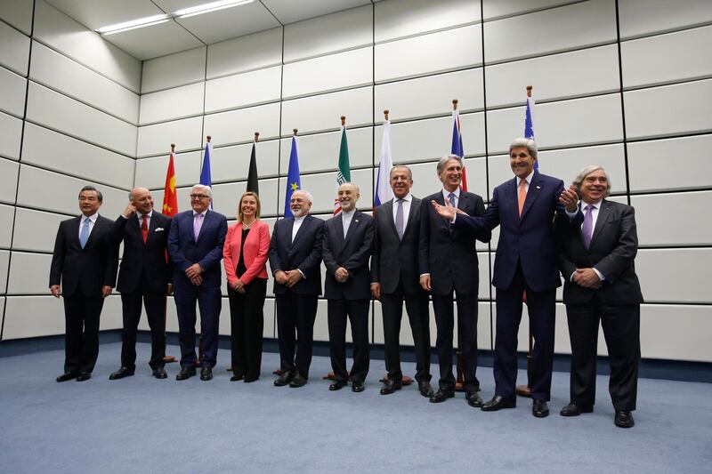 (From L to R) Chinese Foreign Minister Wang Yi, French Foreign Minister Laurent Fabius, German Foreign Minister Frank-Walter Steinmeier, European Union High Representative for Foreign Affairs and Security Policy Federica Mogherini, Iranian Foreign Minister Mohammad Javad Zarif, Head of the Iranian Atomic Energy Organization Ali Akbar Salehi, Russian Foreign Minister Sergey Lavrov, British Foreign Secretary Philip Hammond, US Secretary of State John Kerry and US Secretary of Energy Ernest Moniz pose for a group picture at the United Nations building in Vienna, Austria July 14, 2015. Iran and six major world powers reached a nuclear deal, capping more than a decade of on-off negotiations with an agreement that could potentially transform the Middle East, and which Israel called an "historic surrender".      AFP PHOTO / POOL / CARLOS BARRIA (Photo by CARLOS BARRIA / POOL / AFP)