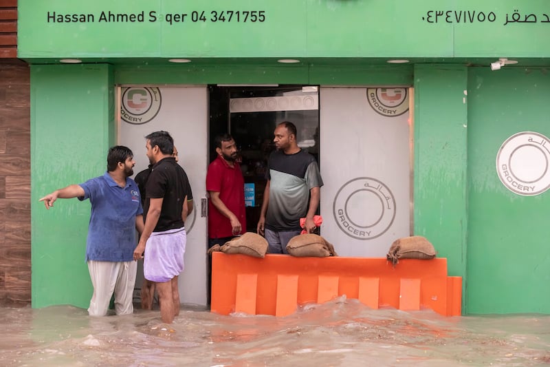 Trying to keep flooding out of a business in Al Quoz, Dubai. According to some measurements, 158mm of rain fell in 24 hours. 
Antonie Robertson / The National