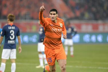 (FILES) This file photo taken on March 1, 2019 shows Marouane Fellaini of Shandong Luneng celebrating after scored during the Chinese Super League (CSL) football match between Shandong Luneng and Beijing Renhe in Jinan in China's eastern Shandong province. With nagging concerns about coronavirus sweeping through teams and players scattered across the world, unable or hesitant to return, China is finding that restarting football is no simple matter. - China OUT / AFP / STR